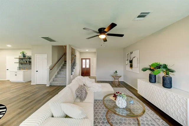 a living room with furniture and a potted plant