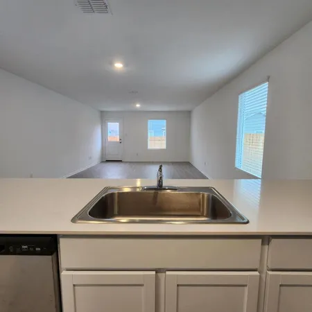 a sink and dishwasher with granite countertops