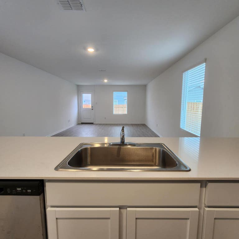 543 Commander Abbott Drive Jarrell, TX 76537 - Photo 8 of 12 a sink and dishwasher with granite countertops