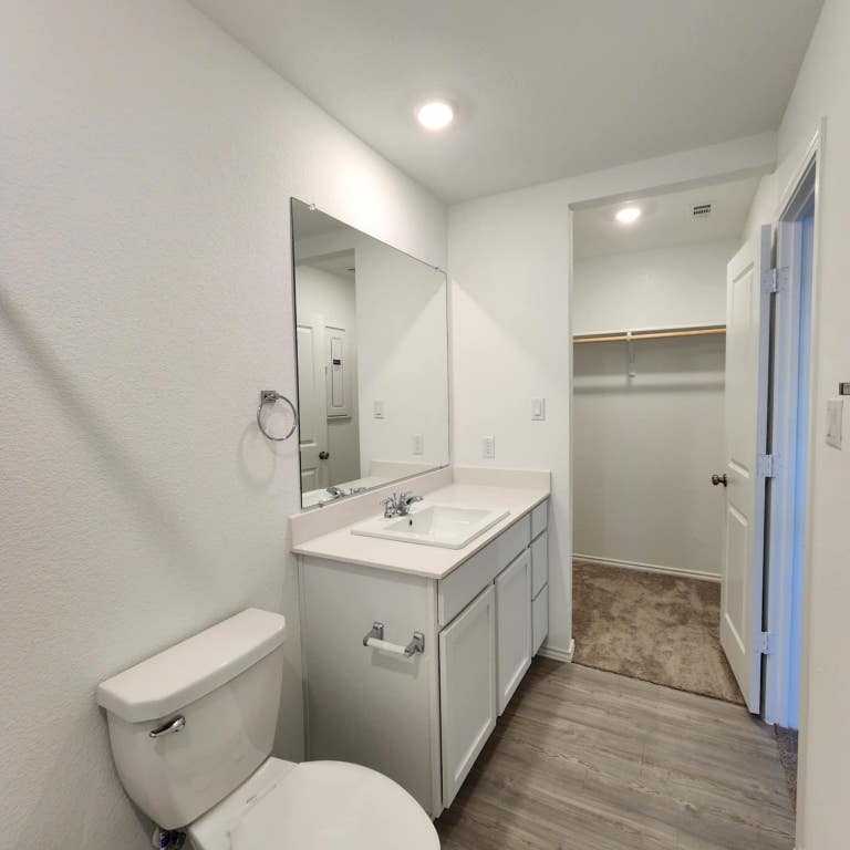 543 Commander Abbott Drive Jarrell, TX 76537 - Photo 9 of 12 a bathroom with a toilet sink and mirror