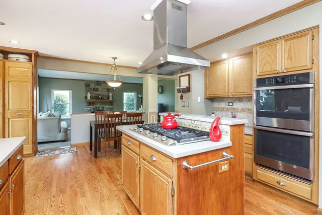 a kitchen with stainless steel appliances granite countertop a stove refrigerator and cabinets