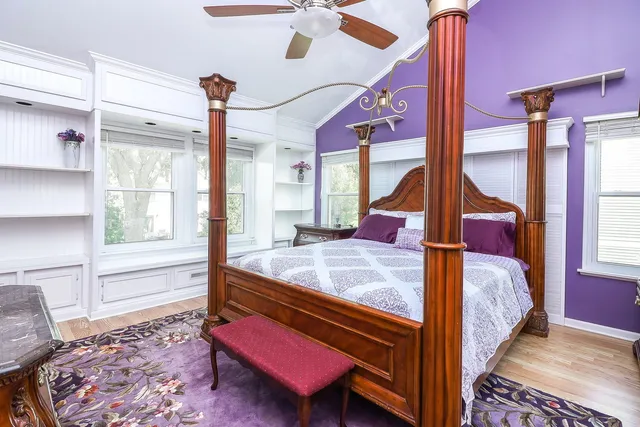 a bed room with a bed and windows