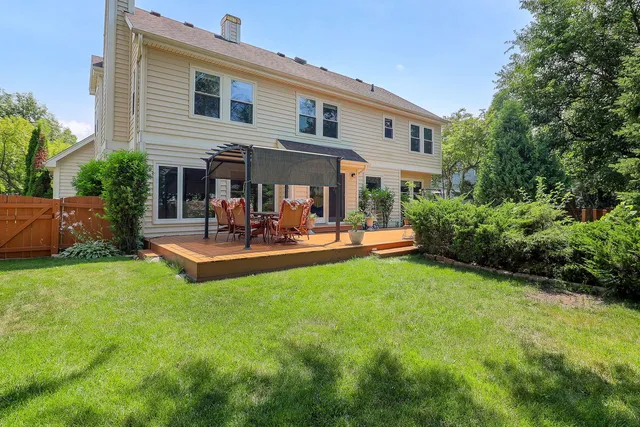 a view of a patio with couches and a table and chairs with plants and trees