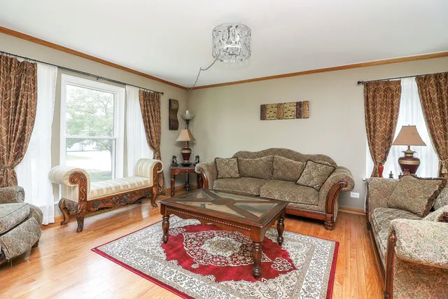 a living room with furniture a rug and a large window