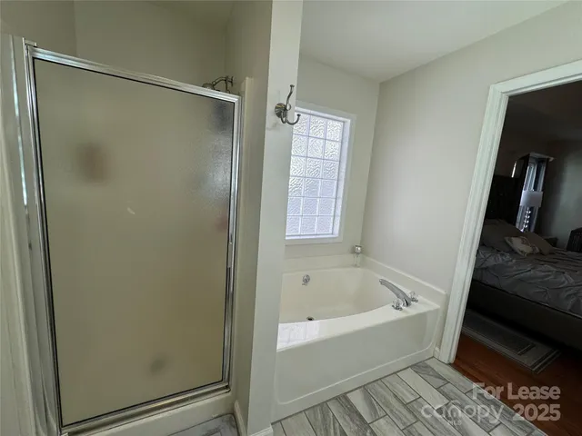 a bathroom with a bathtub and a shower