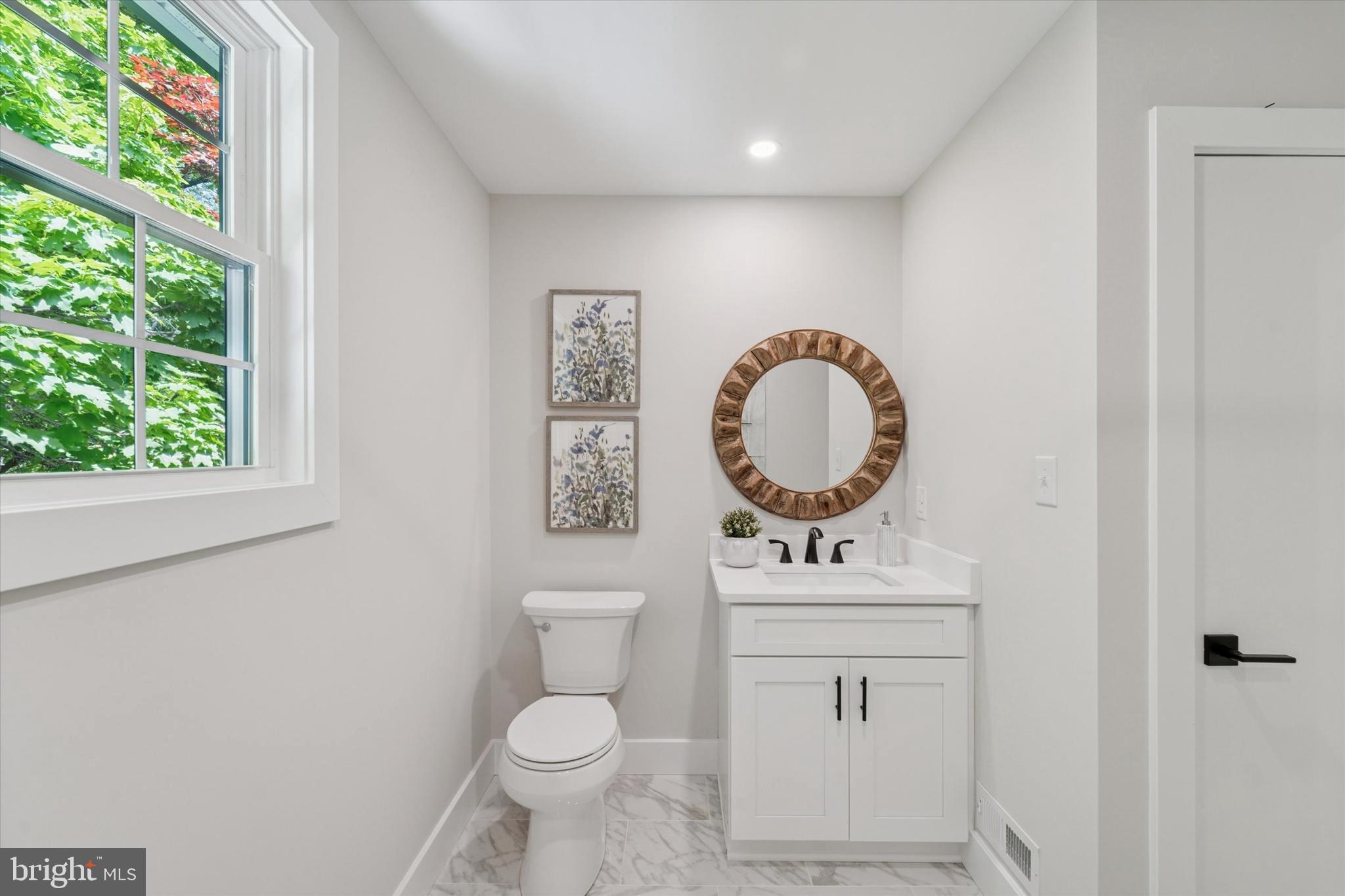 130 Walnut Avenue Pitman, NJ 08071 - Photo 24 of 35 a bathroom with a toilet a sink a mirror and a window