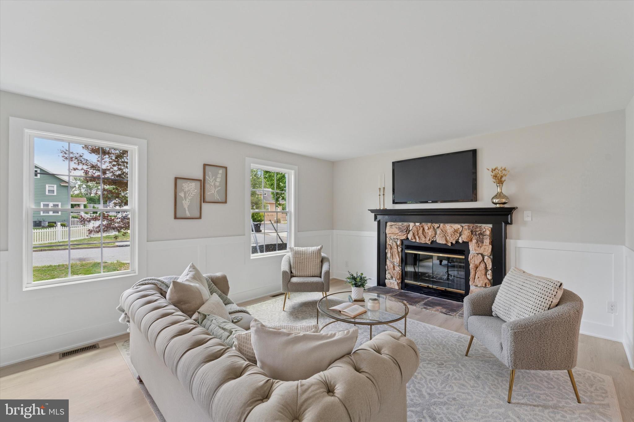 130 Walnut Avenue Pitman, NJ 08071 - Photo 4 of 35 a living room with furniture a fireplace and a flat screen tv