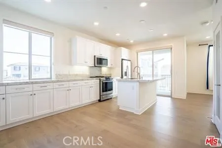 a large kitchen with kitchen island a sink a center island and a window
