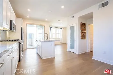 a kitchen with a refrigerator and a sink