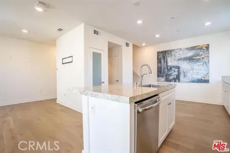 a kitchen with granite countertop a sink and cabinets