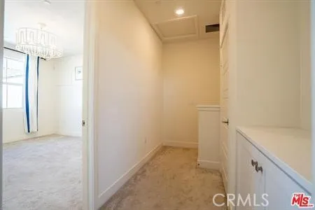 a view of a hallway with closet and wooden floor