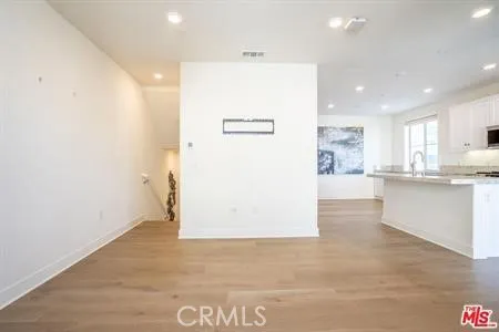 a view of kitchen with refrigerator and window