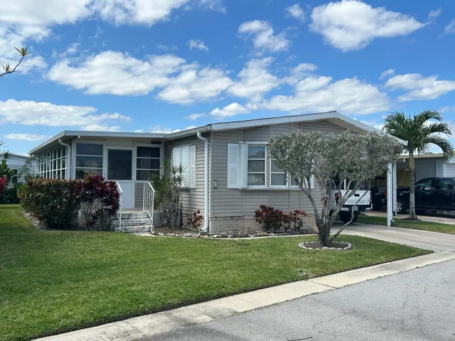 a view of a house with a yard and plants