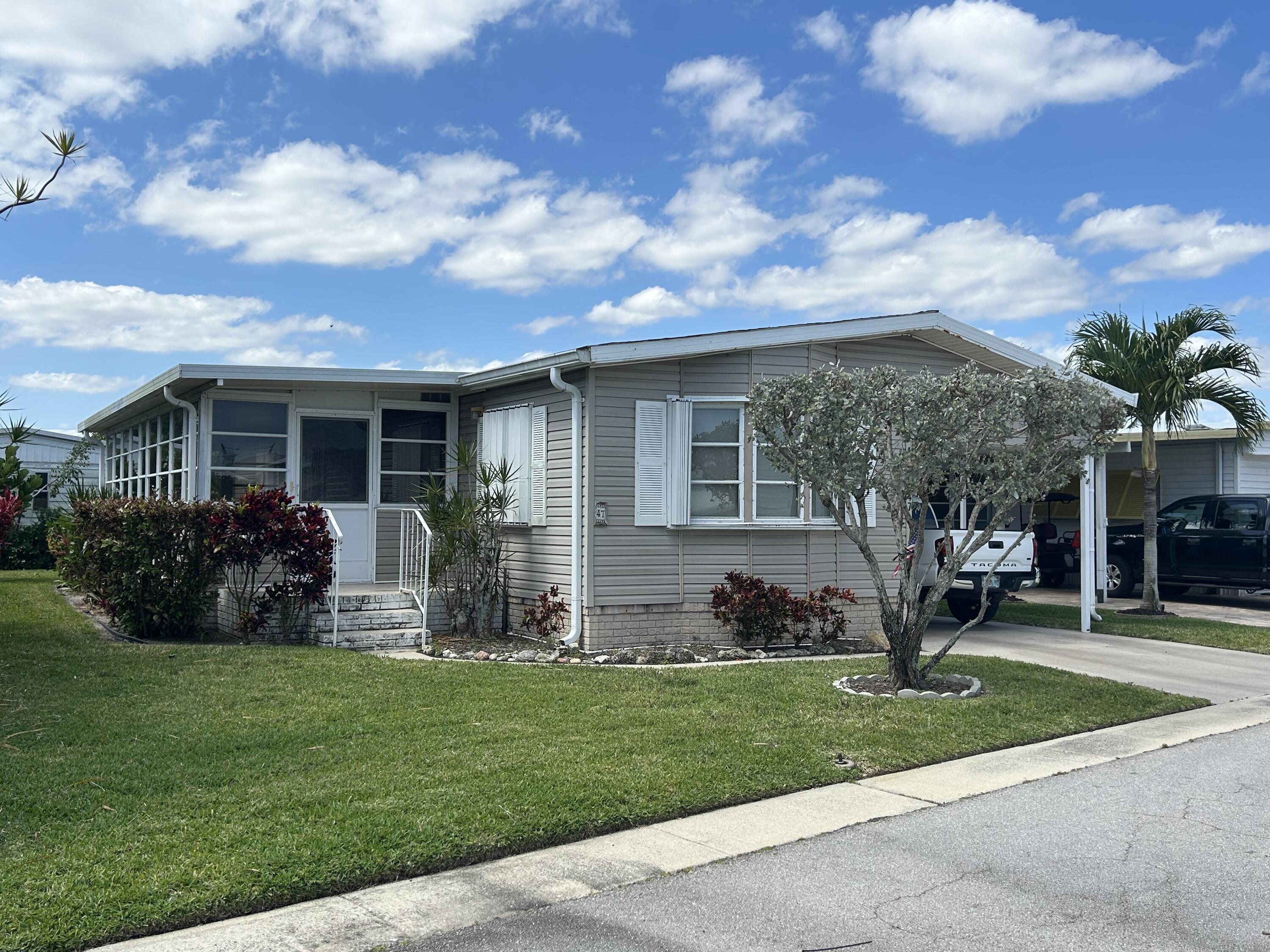 a view of a house with a yard and plants