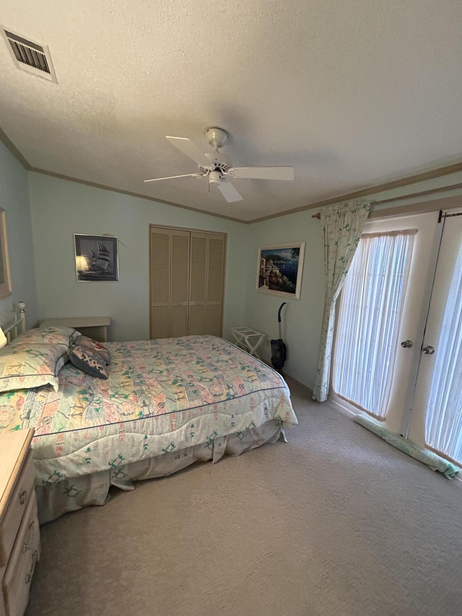 400 North Hwy A1A, Unit 47 Jupiter, FL 33477 - Photo 13 of 35 a bedroom with bed and window