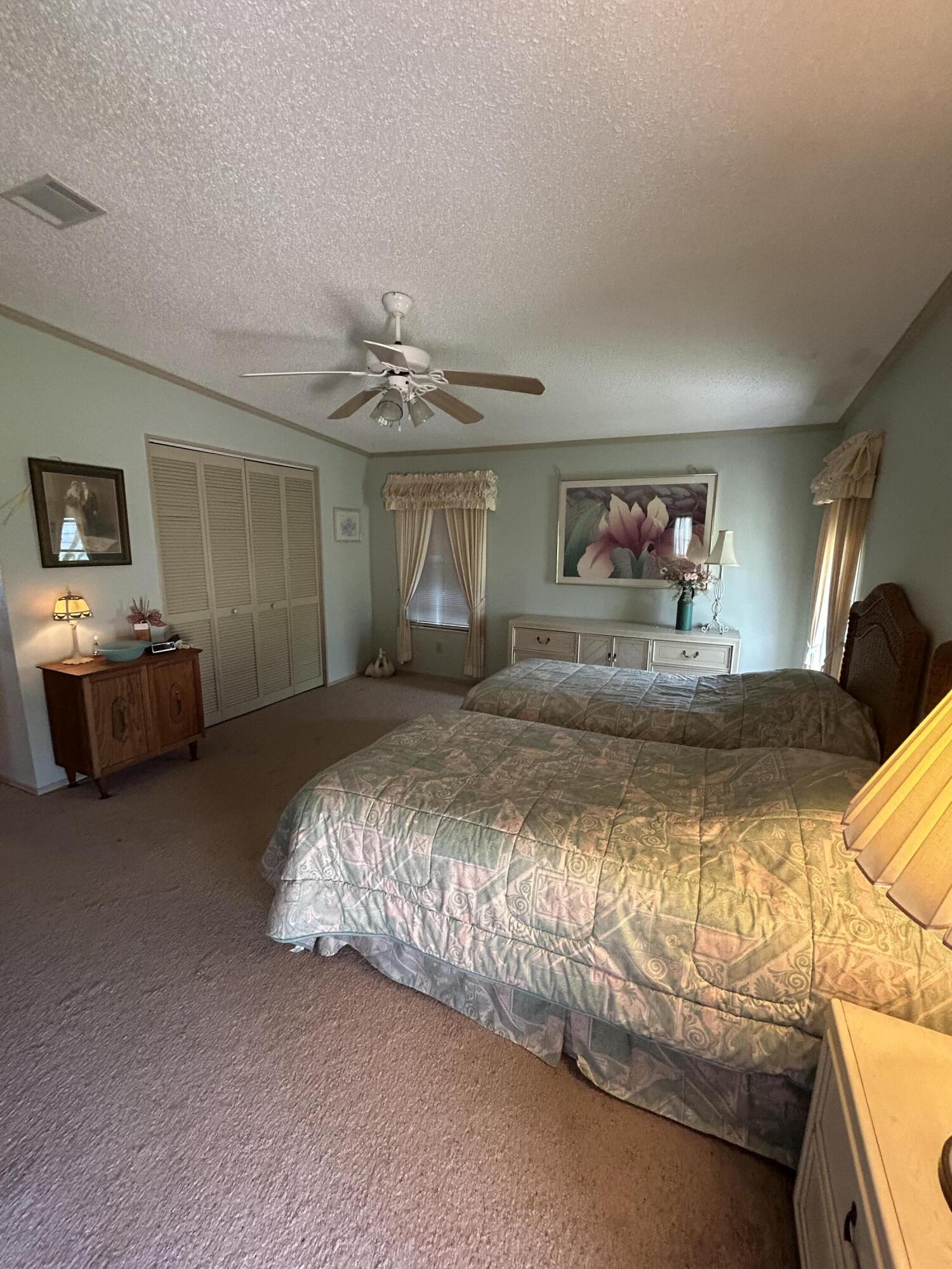 400 North Hwy A1A, Unit 47 Jupiter, FL 33477 - Photo 14 of 35 a bedroom with a bed and dresser