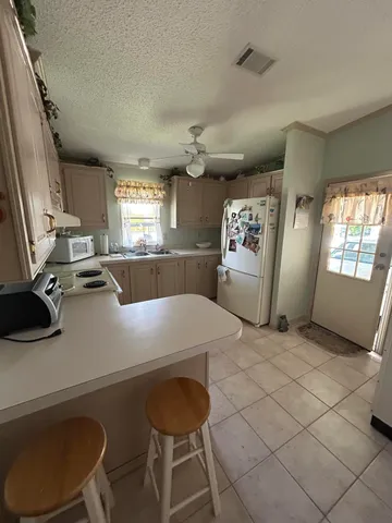 a kitchen with a cabinets and white stainless steel appliances