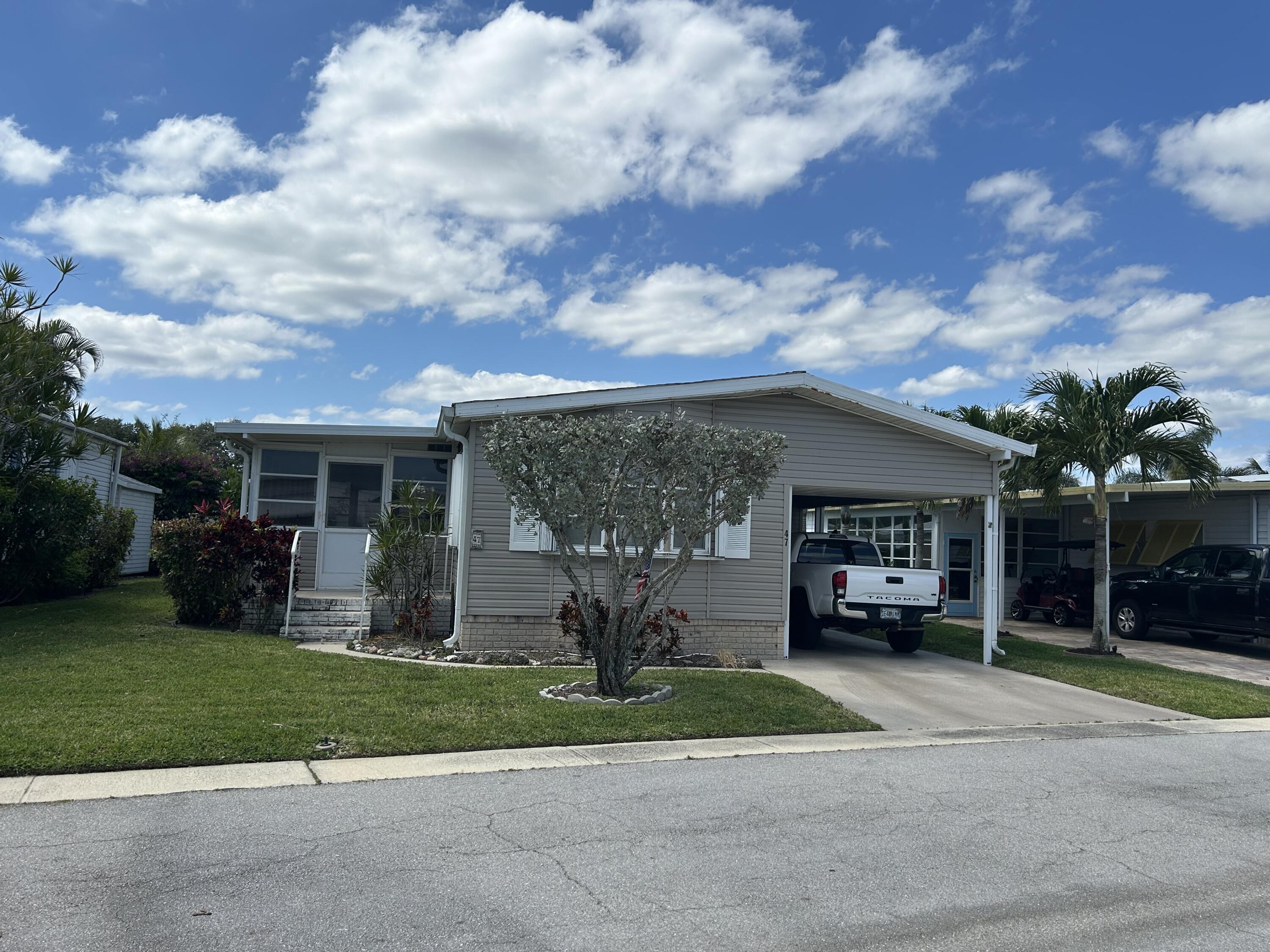 400 North Hwy A1A, Unit 47 Jupiter, FL 33477 - Photo 3 of 35 a front view of a house with garden