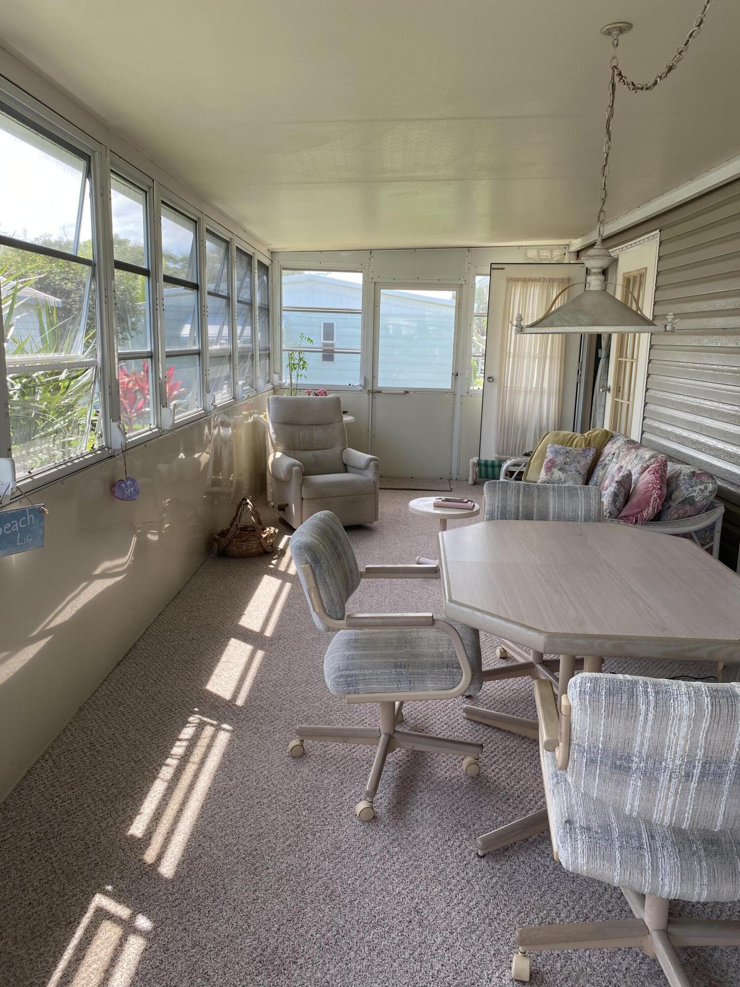 400 North Hwy A1A, Unit 47 Jupiter, FL 33477 - Photo 10 of 35 a living room with furniture and a table
