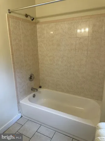 a bathroom with a shower and a bath tub