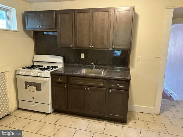 a kitchen with a sink and a stove