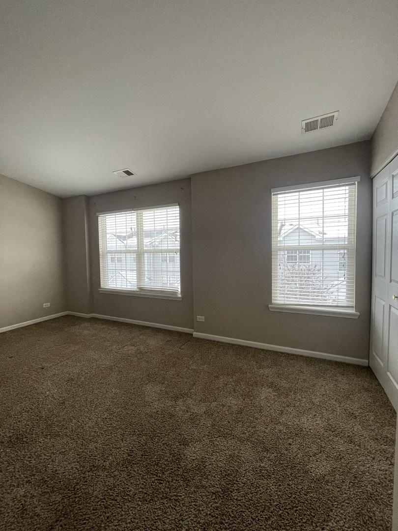 578 Triumph Court, Unit 578 Hainesville, IL 60073 - Photo 13 of 20 an empty room with a window