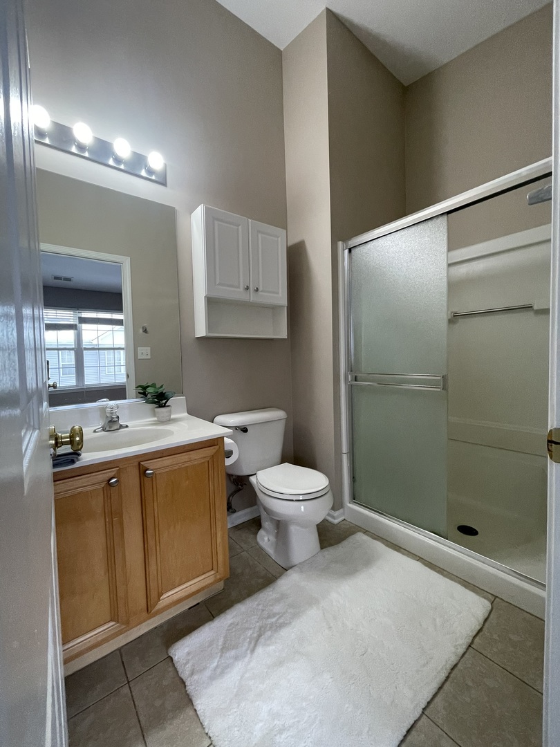 578 Triumph Court, Unit 578 Hainesville, IL 60073 - Photo 15 of 20 a bathroom with a granite countertop sink toilet and shower