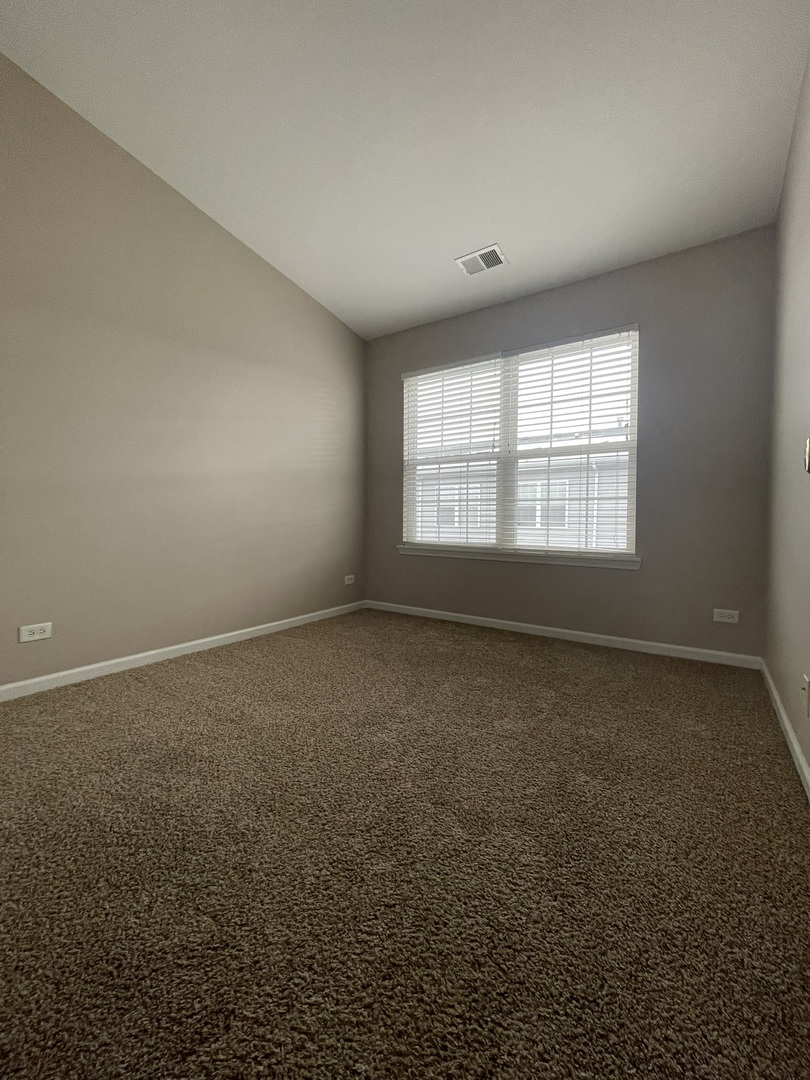 578 Triumph Court, Unit 578 Hainesville, IL 60073 - Photo 16 of 20 an empty room with a window