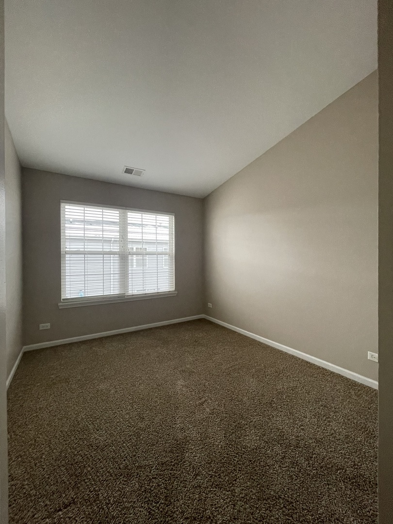 578 Triumph Court, Unit 578 Hainesville, IL 60073 - Photo 17 of 20 an empty room with a window