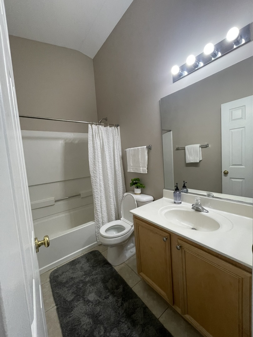 578 Triumph Court, Unit 578 Hainesville, IL 60073 - Photo 18 of 20 a bathroom with a sink a toilet a mirror and shower