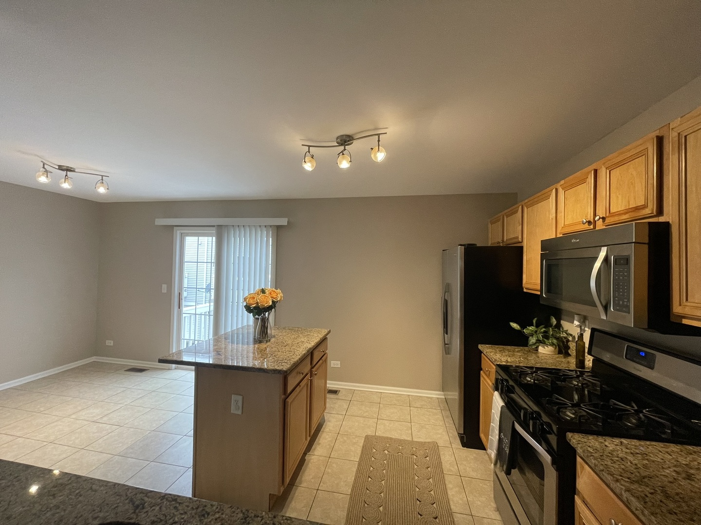 578 Triumph Court, Unit 578 Hainesville, IL 60073 - Photo 8 of 20 a kitchen with a refrigerator and a stove top oven