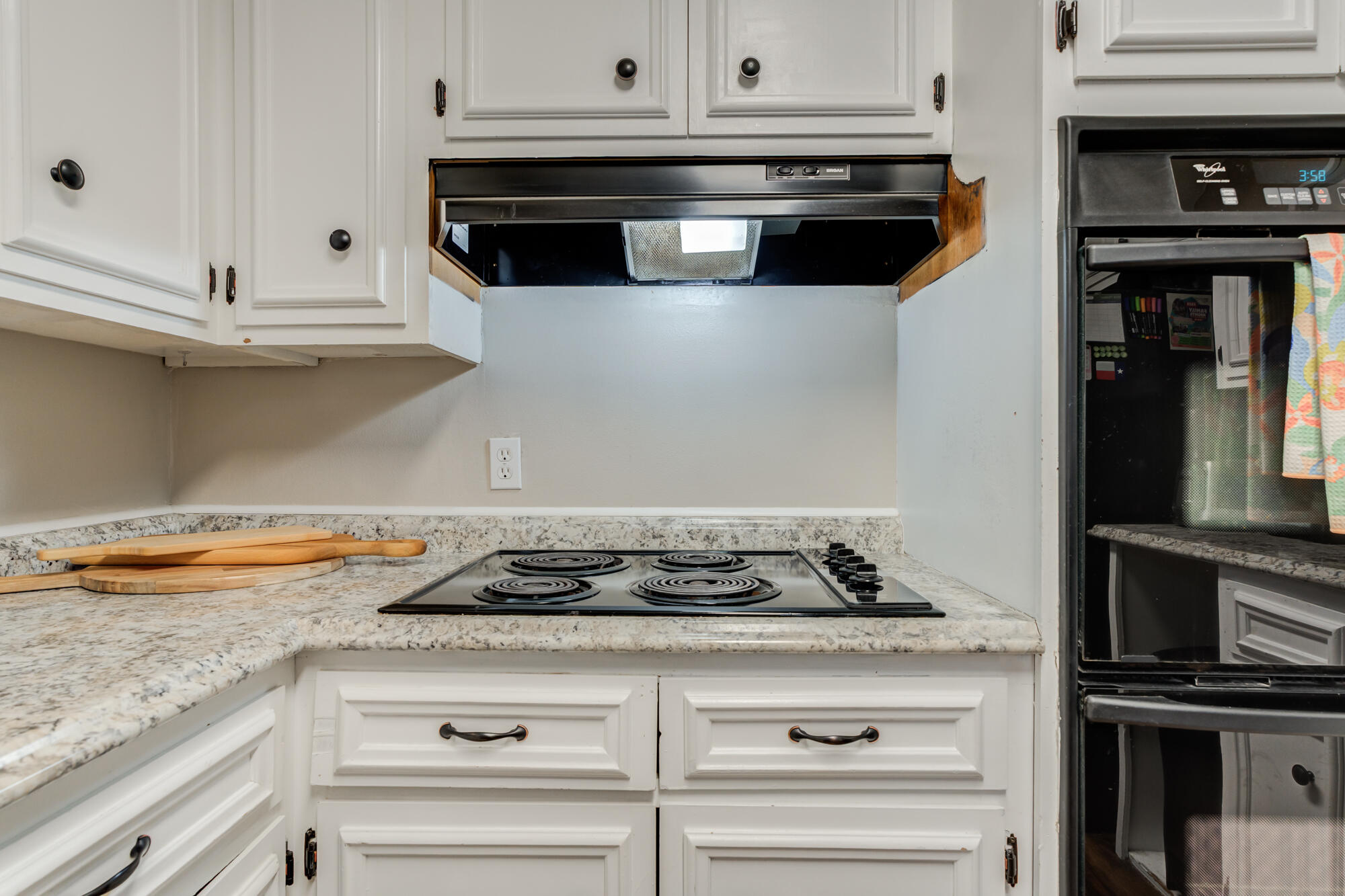1912 69th Street Lubbock, TX 79412 - Photo 18 of 41 a stove top oven sitting inside of a kitchen