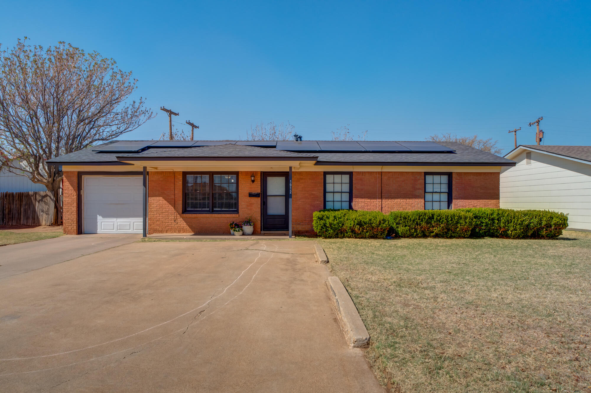 1912 69th Street Lubbock, TX 79412 - Photo 2 of 41 front view of house with a yard