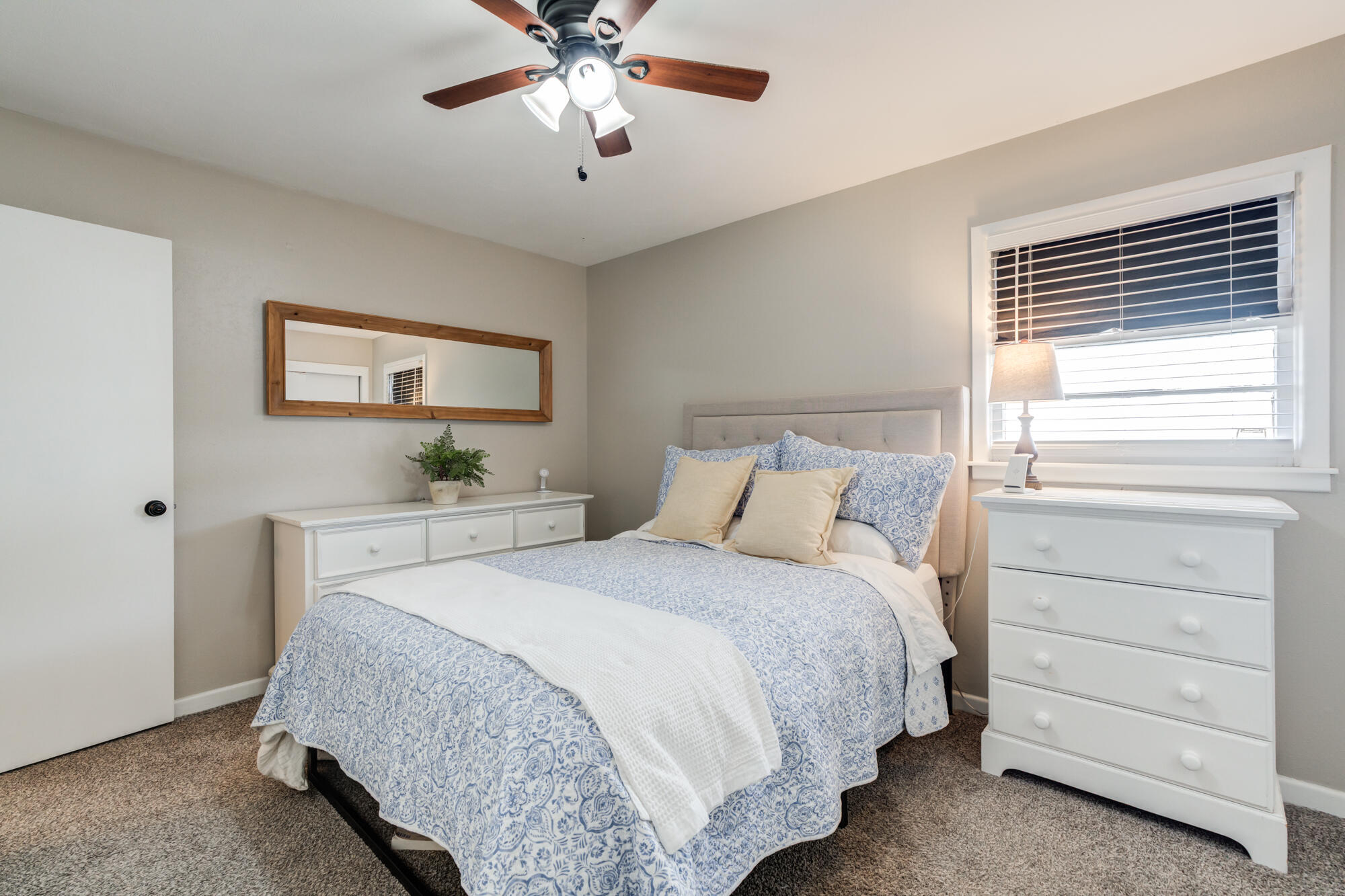 1912 69th Street Lubbock, TX 79412 - Photo 24 of 41 a bedroom with a bed and a chandelier