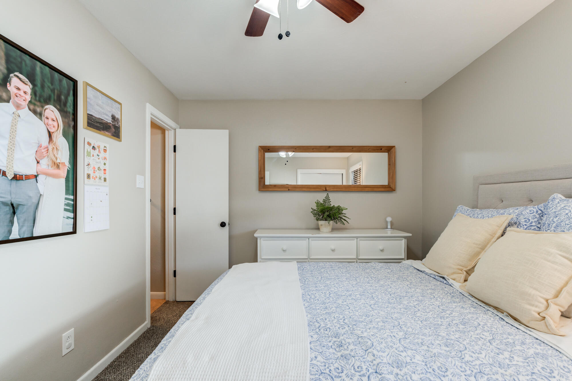 1912 69th Street Lubbock, TX 79412 - Photo 25 of 41 a bedroom with a bed and a chandelier