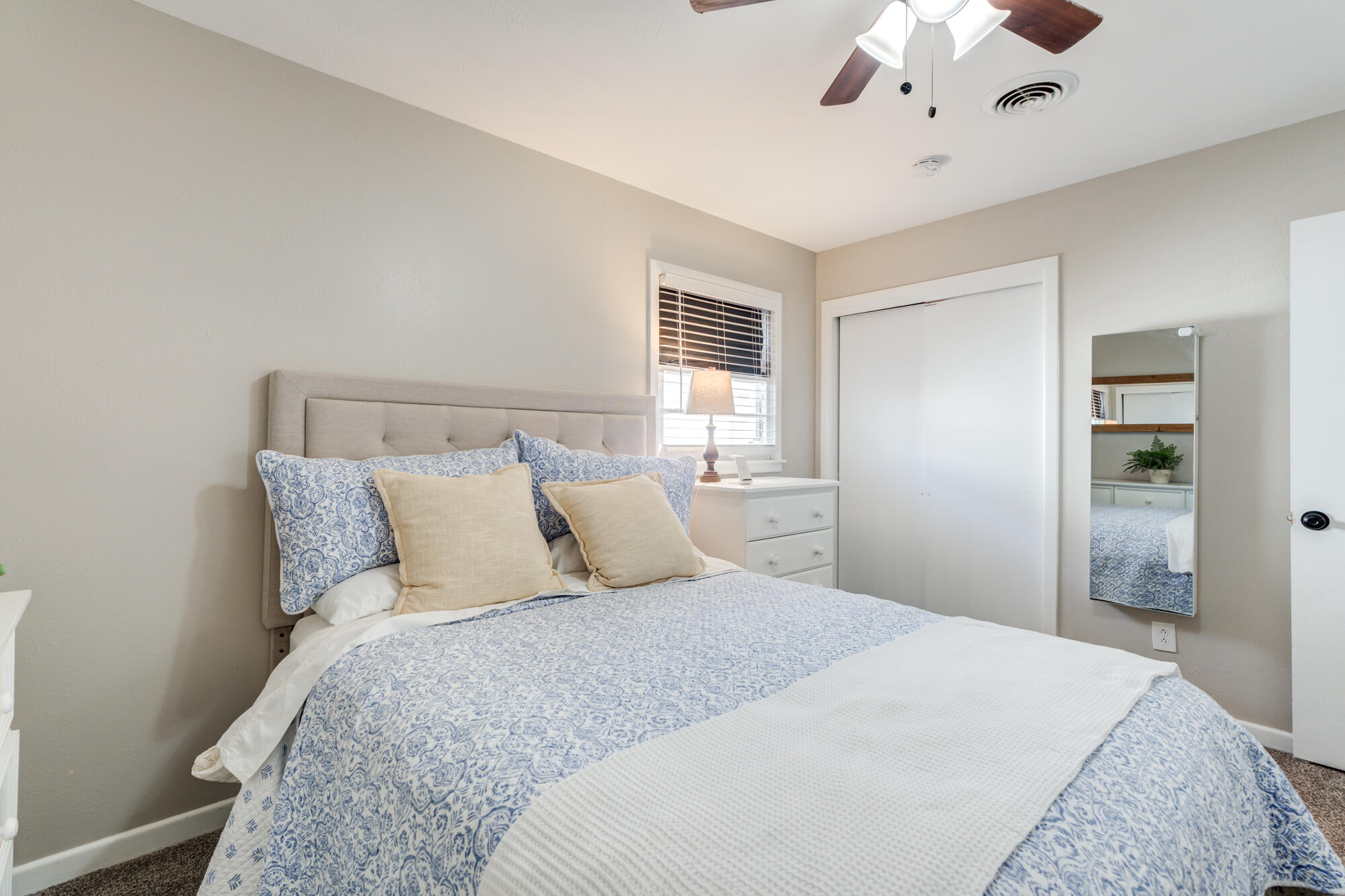 1912 69th Street Lubbock, TX 79412 - Photo 26 of 41 a bedroom with a large bed and a chandelier