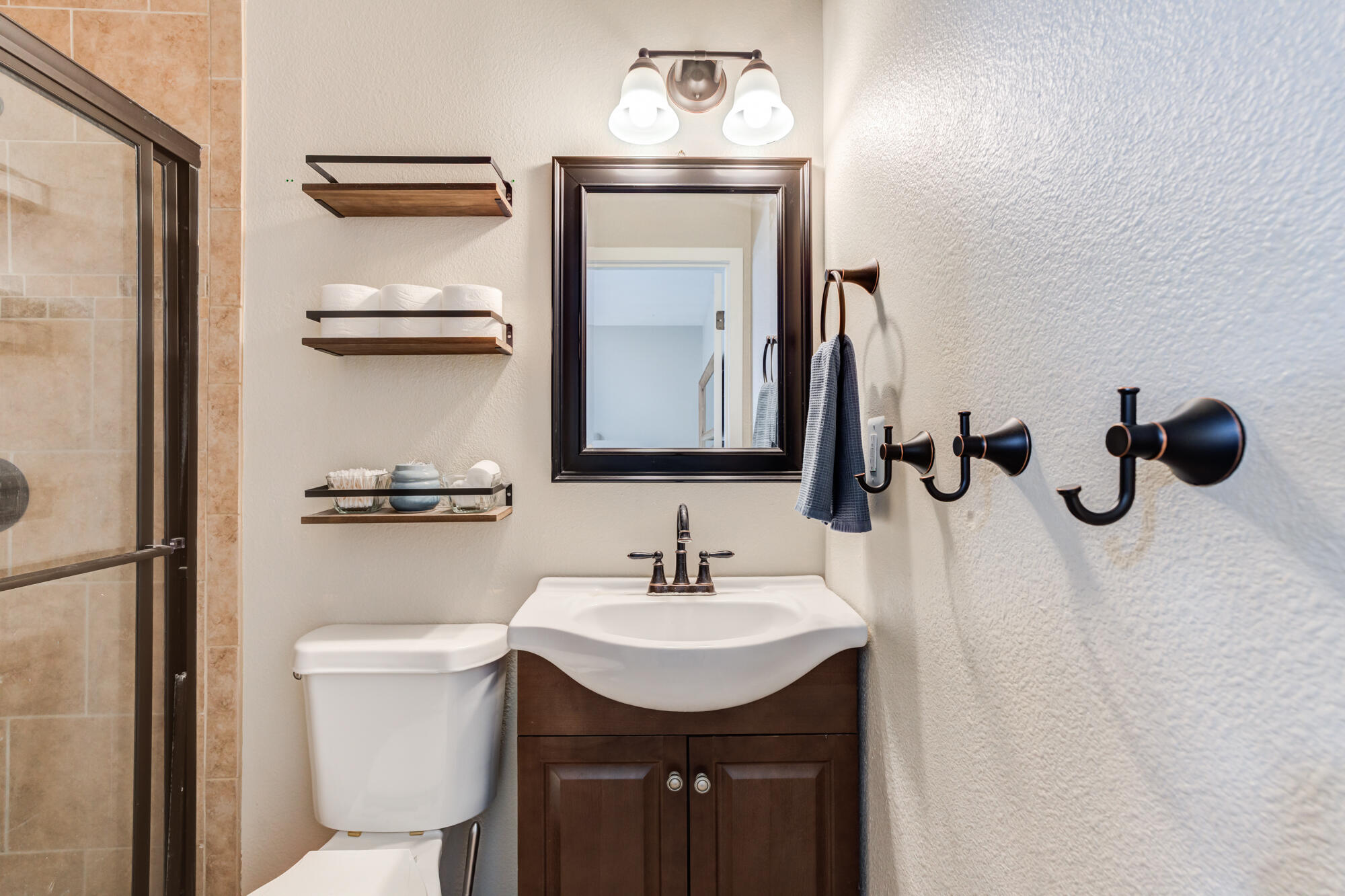 1912 69th Street Lubbock, TX 79412 - Photo 28 of 41 a bathroom with a toilet sink and mirror