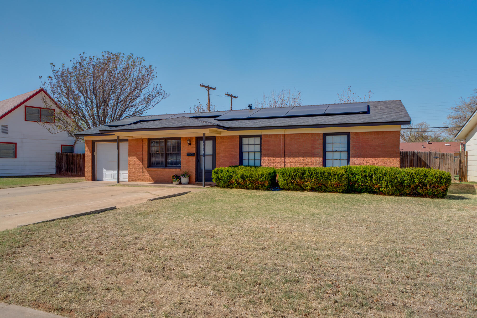 1912 69th Street Lubbock, TX 79412 - Photo 3 of 41 a front view of a house with garden