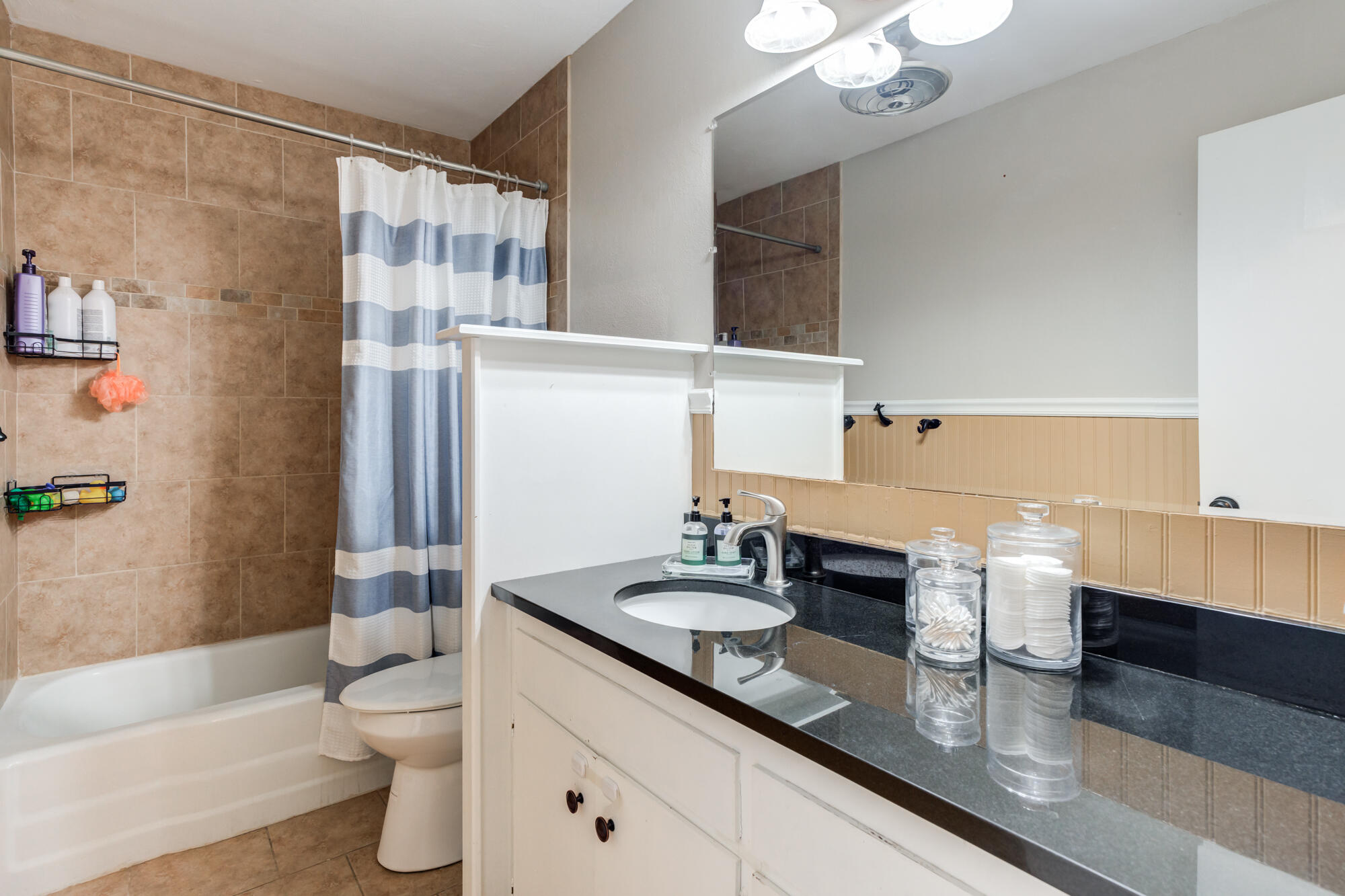 1912 69th Street Lubbock, TX 79412 - Photo 32 of 41 a bathroom with a double vanity sink toilet and shower