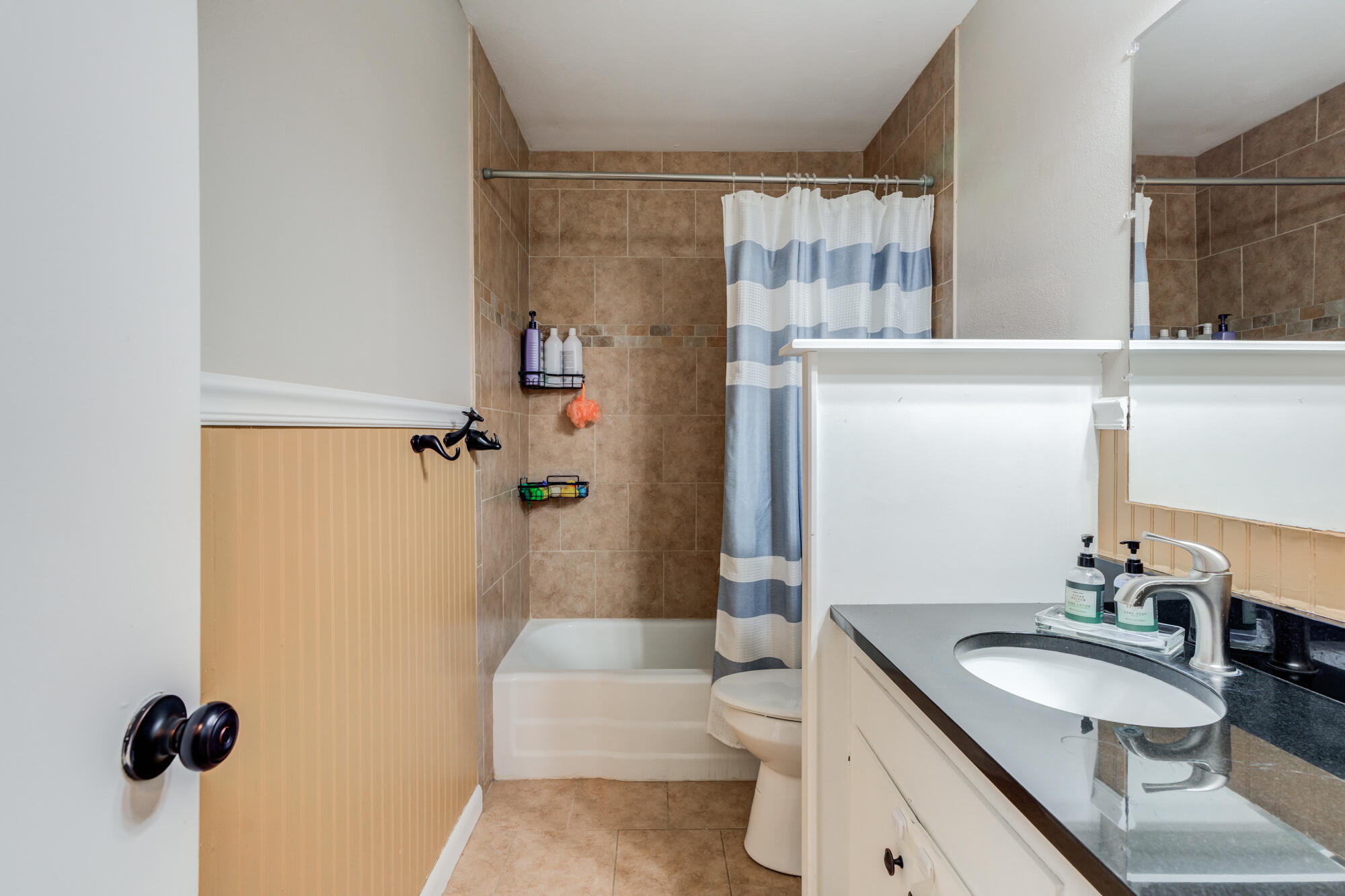 1912 69th Street Lubbock, TX 79412 - Photo 33 of 41 a bathroom with a sink a toilet a mirror and shower