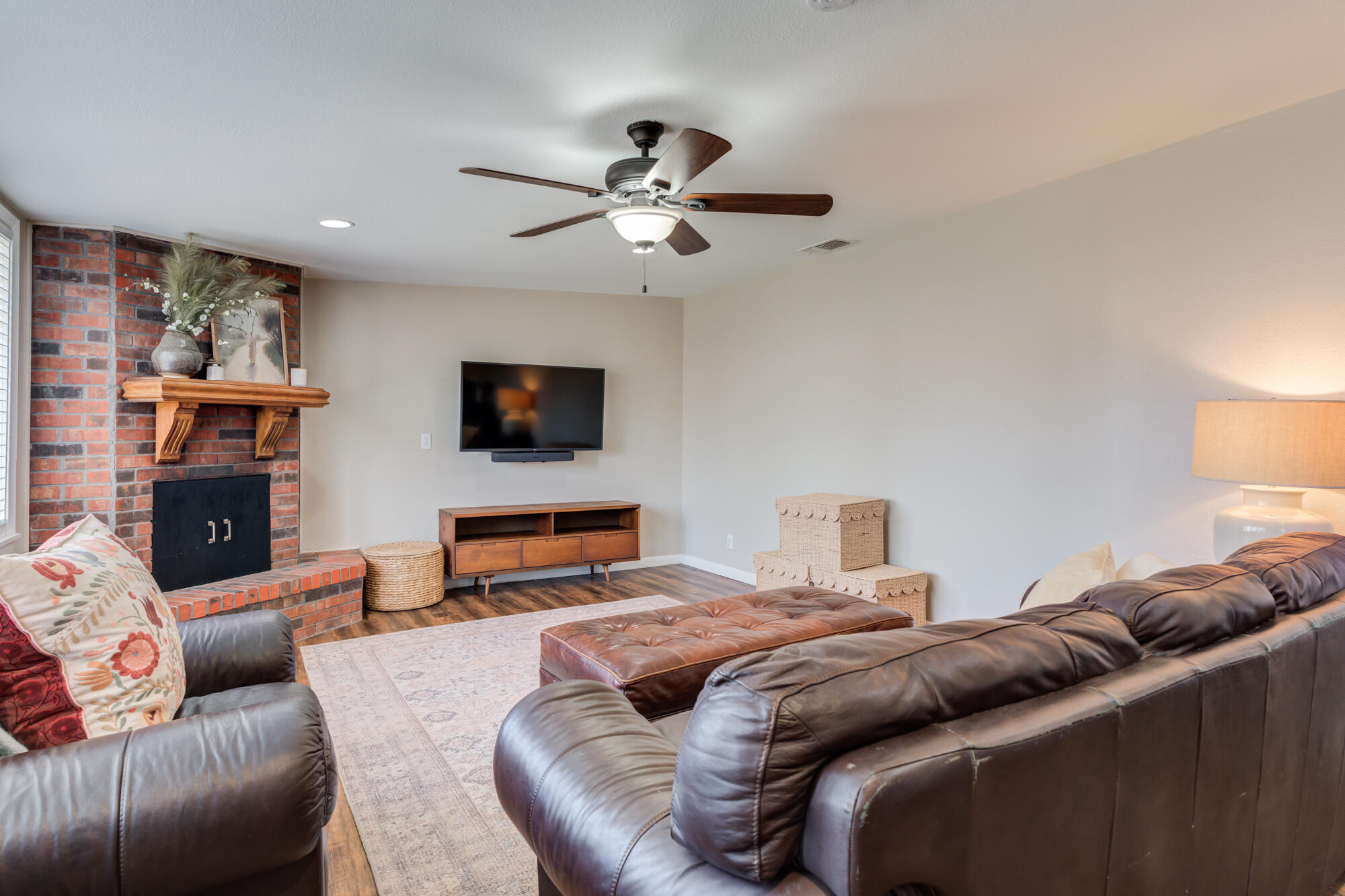 1912 69th Street Lubbock, TX 79412 - Photo 7 of 41 a bedroom with a bed a couch and a flat screen tv