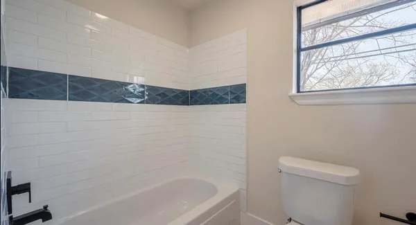 a bathroom with a bathtub and window