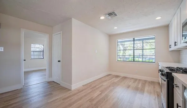 a view of wooden floor and windows in a room