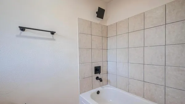 a bathroom with a bathtub and shower