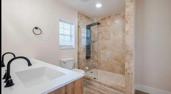 a bathroom with a bathtub and shower