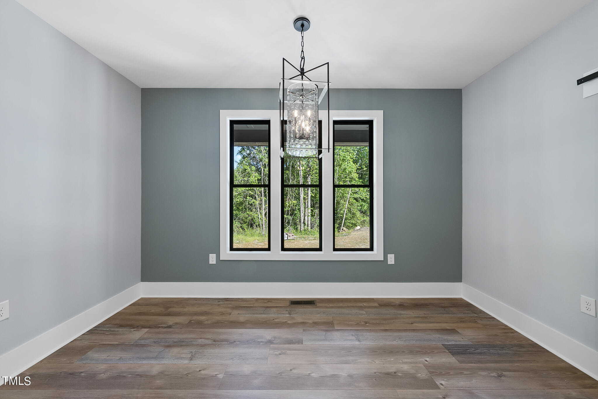 190 Pilot Ridge Road Zebulon, NC 27597 - Photo 23 of 55 a view of an empty room with wooden floor and a window