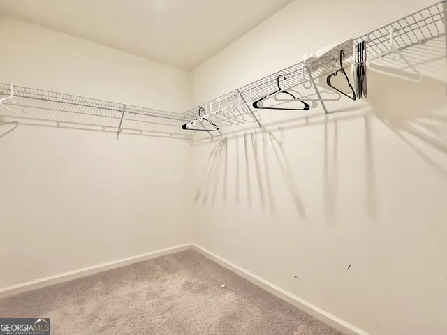 a bedroom with two beds and a window