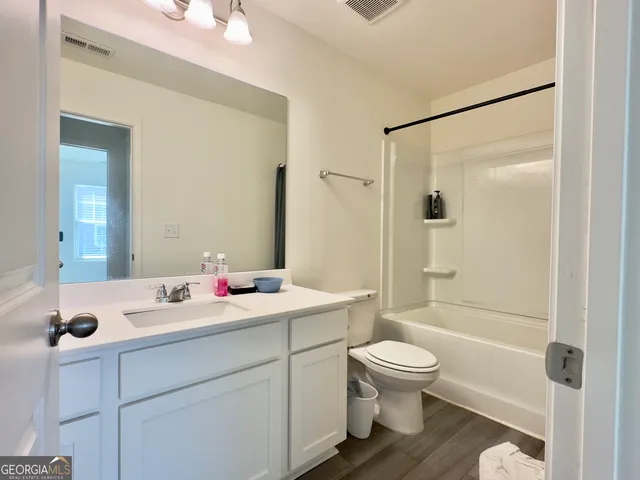 a bathroom with a toilet a sink and a mirror