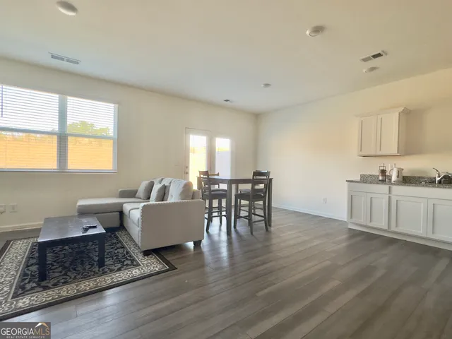 a view of a dining room with furniture and wooden floor