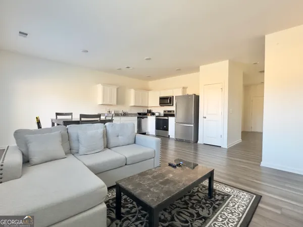 a view of a livingroom with furniture and a window